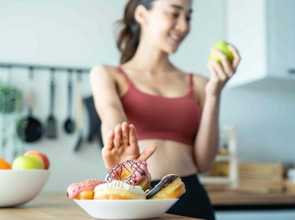 asian-attractive-active-woman-pick-up-a-green-appl-2023-11-27-05-20-35-utc-min