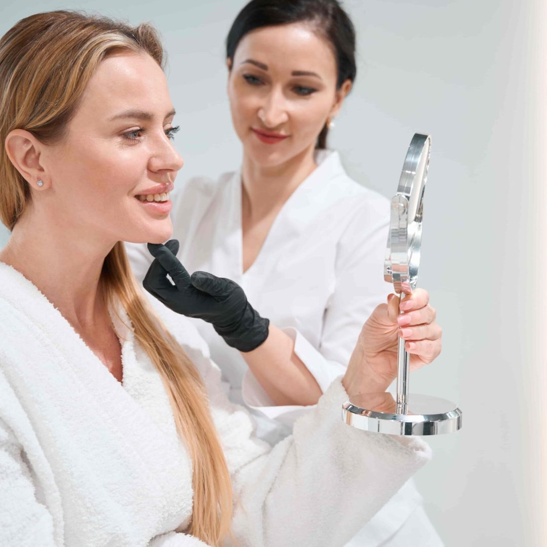 patient-of-cosmetology-clinic-examines-her-face-af-2023-11-27-05-09-33-utc-min
