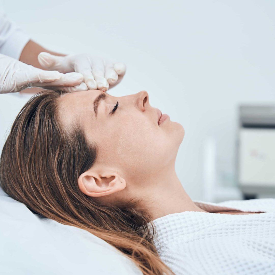 pleased-brunette-woman-lying-on-couch-in-salon-2023-11-27-05-14-23-utc-min