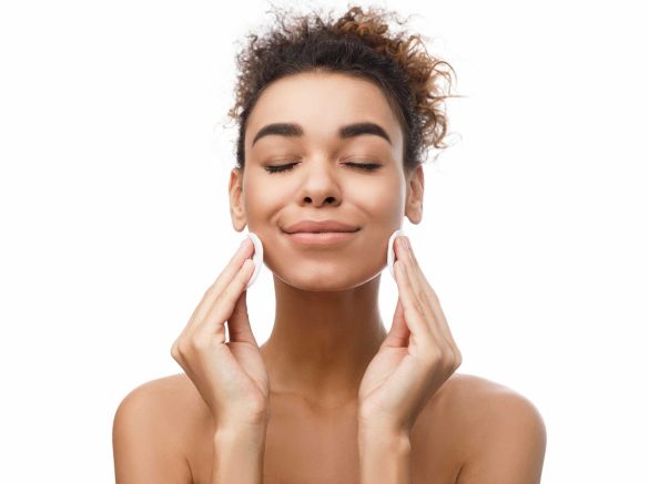 young-woman-cleaning-her-face-with-cotton-pads-X8GQ27L.jpg